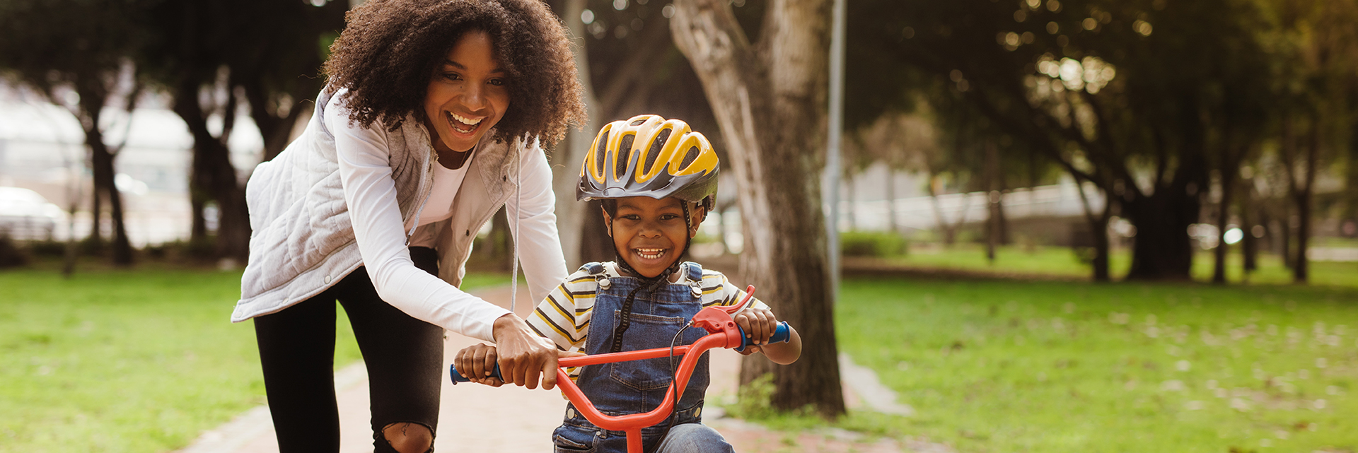 Mother teaching son to ride bicycle