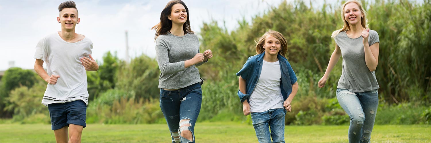 kids running in the field on a nice day